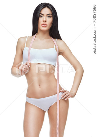 Slim tanned woman's body isolated on white background - waist measurement 70857666