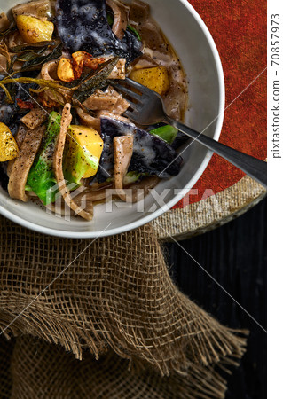 pasta pizzoccheri with chinese cabbage, potato on dark background. italian traditional dish 70857973
