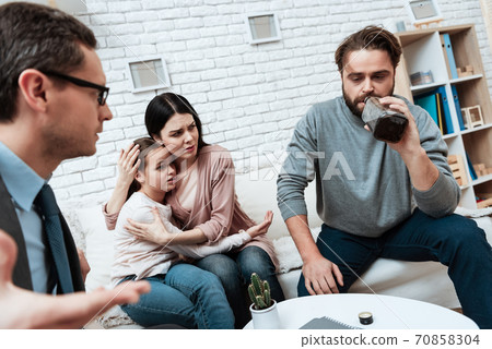 Mom hugs daughter who is afraid of dad.  70858304