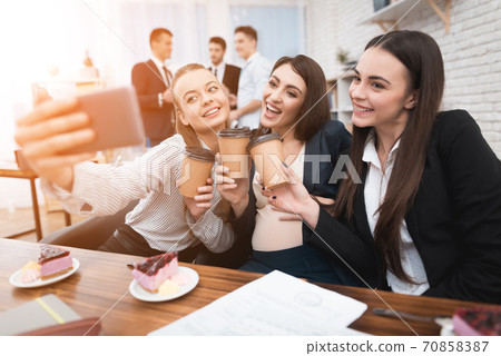 Workers lunch break at table with coffee and cakes 70858387