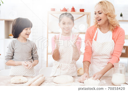 Little girl clapped her hands and dough have fun. 70858420