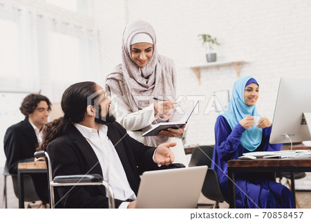 Disabled arab man in suit in wheelchair. 70858457