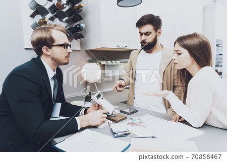 The seller shows price for new kitchen to buyers.  70858467