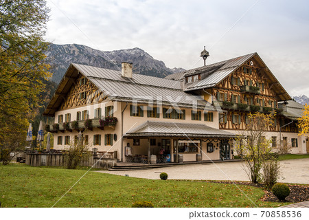 A large traditional Bavarian house against the backdrop of the mountains in Fussen 70858536