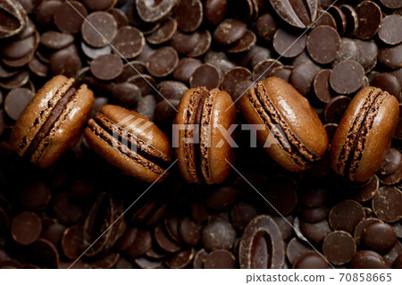 Chocolate-flavored French macaroons are in the bakery. Chocolate-flavored French macaroons are in the bakery. 70858665