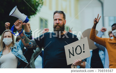 People with placards and posters on public demonstration, no covid vaccine and coronavirus concept. People with placards and posters on public demonstration, no covid vaccine and coronavirus concept. 70859387