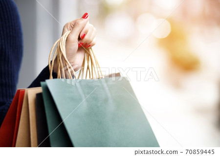 Woman is using shopping at the mall 70859445