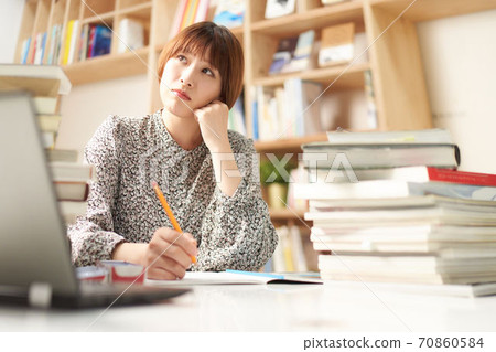 Young woman indulging in thought Young woman indulging in thought 70860584