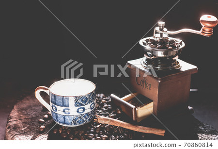 Coffee grinder,coffee beens and blue cup on grunge wood table dark background Coffee grinder,coffee beens and blue cup on grunge wood table dark background 70860814
