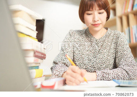A young woman studying 70862073