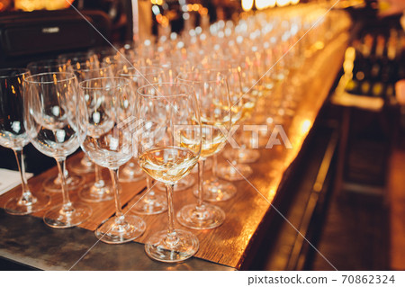 Refreshing White Wine in a Glass on a Background. Refreshing White Wine in a Glass on a Background. 70862324