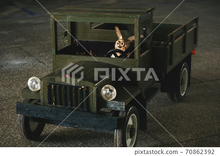 Alert and attentive driver behind the wheel of a wooden truck. Alert and attentive driver behind the wheel of a wooden truck. 70862392