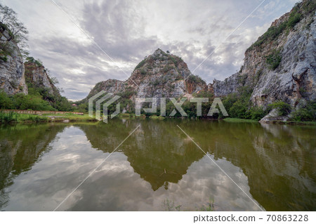 Khao Ngu Stone. National park with reflection of river lake, mountain valley hills, and tropical green forest trees at sunset in Ratchaburi, Thailand in travel trip. Natural landscape background. 70863228
