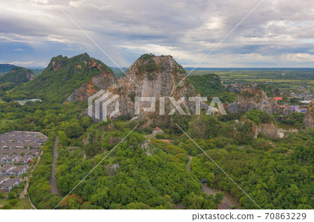 Aerial view of Khao Ngu Stone. National park with river lake, mountain valley hills, and tropical green forest trees at sunset in Ratchaburi, Thailand in travel trip. Natural landscape background. Aerial view of Khao Ngu Stone. National park with river lake, mountain valley hills, and tropical green forest trees at sunset in Ratchaburi, Thailand in travel trip. Natural landscape background. 70863229