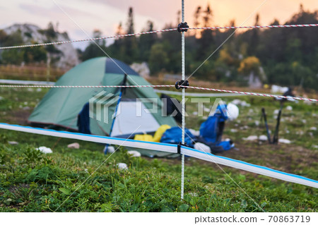 electric fence encloses the tourist camp, preventing bear attacks electric fence encloses the tourist camp, preventing bear attacks 70863719