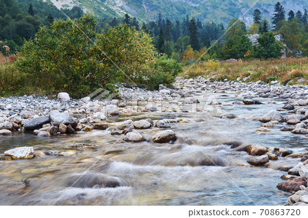 mountain river in autumn landscape, water blurred in motion mountain river in autumn landscape, water blurred in motion 70863720