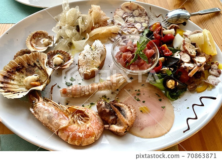Delicious Italian seafood and fish antipasti platter as appetizer on wooden restaurant table. Gourmet food close up, snack, antipasti, seafood platter 70863871