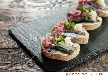 French fish tartines on stone board 70863922