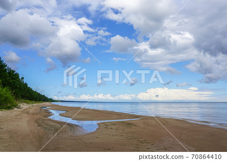 baltic sea coast in latvia in summer, a small stream flows into the sea baltic sea coast in latvia in summer, a small stream flows into the sea 70864410