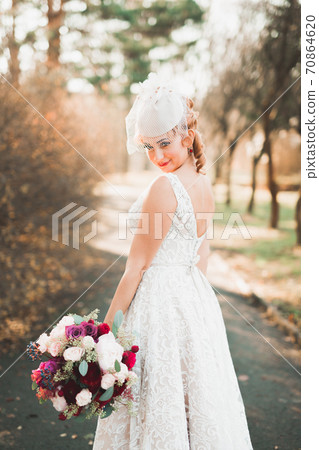 Portrait of a beautiful fashion bride, sweet and sensual. Wedding make up and hair Portrait of a beautiful fashion bride, sweet and sensual. Wedding make up and hair 70864620