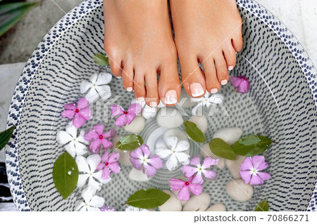 Beautiful woman legs and different spa items.Well manicured and pedicured nails. 70866271