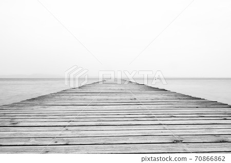 The view along a wooden pier from the resort town of Sirmione on the banks of Lake Garda in north east Italy. The view along a wooden pier from the resort town of Sirmione on the banks of Lake Garda in north east Italy. 70866862