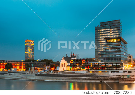 Cologne, Germany. Modern Building On Embankment During Summer Evening Night Cologne, Germany. Modern Building On Embankment During Summer Evening Night 70867286