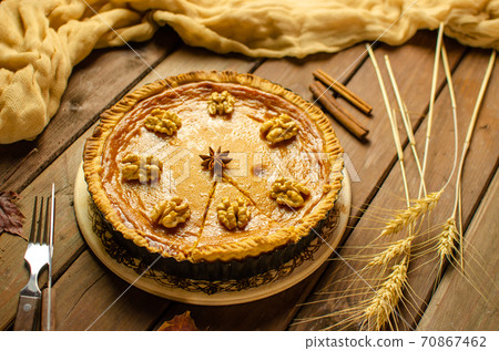 Fresh Homemade Pumpkin Pie on rustic wooden background made for Thanksgiving or halloween. Fresh Homemade Pumpkin Pie on rustic wooden background made for Thanksgiving or halloween. 70867462