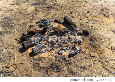 Burnt wood and coals from a recent campfire in The Blue Mountains in regional New South Wales in Australia Burnt wood and coals from a recent campfire in The Blue Mountains in regional New South Wales in Australia 70868290
