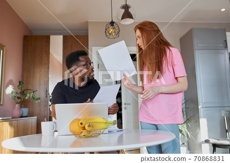 female listening to emotional husband holding documents at home female listening to emotional husband holding documents at home 70868831