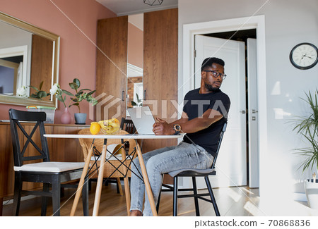 working man sit at table and looking away working man sit at table and looking away 70868836