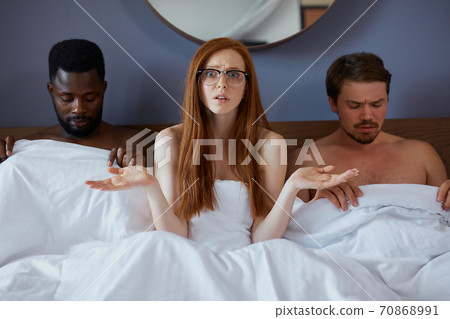 african and caucasian men lie on bed with redhead sexy woman african and caucasian men lie on bed with redhead sexy woman 70868991