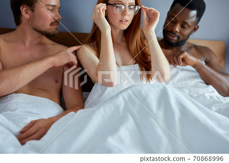threesome concept. three people going to have group sex together 70868996