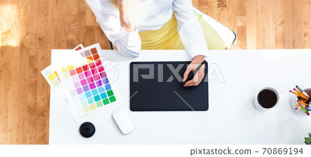 Graphic designer using her graphic tablet Graphic designer using her graphic tablet 70869194