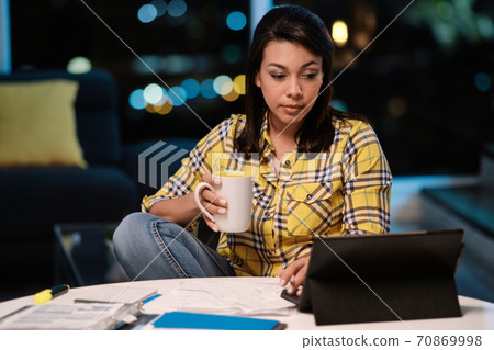 Latin American Woman Working from Home At Night 70869998