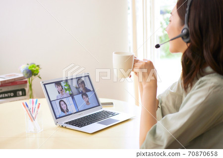 Woman having an online meeting in the living room Woman having an online meeting in the living room 70870658