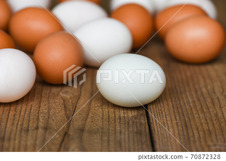 Fresh Chicken eggs and duck eggs on wooden background - white and brown egg 70872328