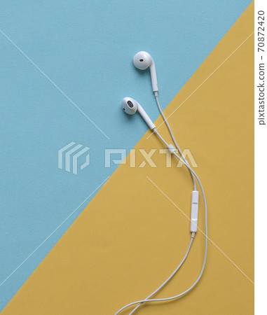 Ear phones on blue and yellow background Ear phones on blue and yellow background 70872420