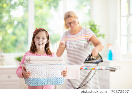 Woman ironing clothes. Home chores. Woman ironing clothes. Home chores. 70872997
