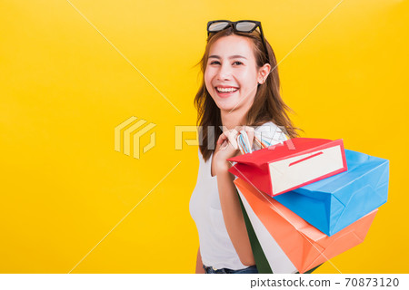 woman teen smiling standing with sunglasses excited holding shopping bags multi color woman teen smiling standing with sunglasses excited holding shopping bags multi color 70873120