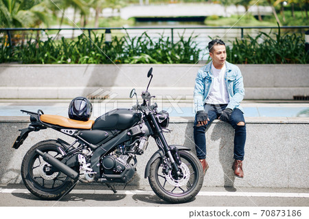 Motorcyclist resting after ride 70873186