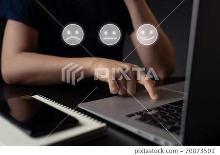 Woman using laptop and emoticon hologram effect. 70873501