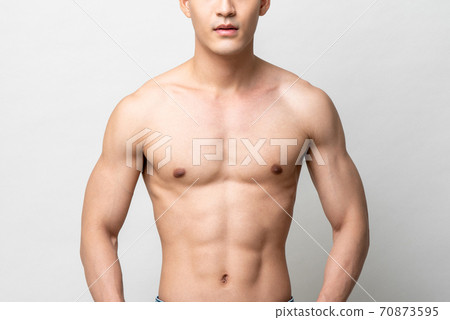 Healthy muscular upper body of a shirtless man isolated gray studio background 70873595