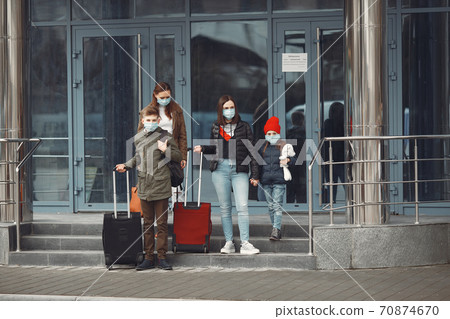 Travelers leaving airport are wearing protective masks Travelers leaving airport are wearing protective masks 70874670