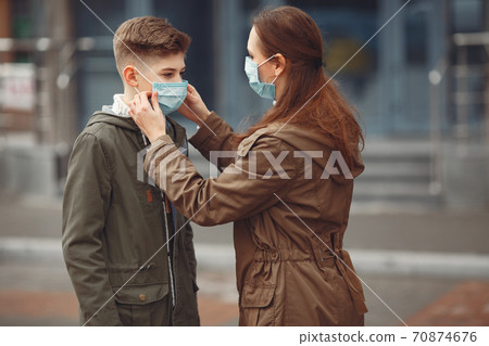 A boy and mother are wearing protective masks 70874676