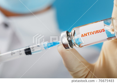 Ampoule with the inscription ANTI-VIRUS with a syringe in the hands of a scientist doctor in rubber gloves with a vaccine close-up. Cure for influenza, measles, coronavirus, covid-19 vaccine disease, Ampoule with the inscription ANTI-VIRUS with a syringe in the hands of a scientist doctor in rubber gloves with a vaccine close-up. Cure for influenza, measles, coronavirus, covid-19 vaccine disease, 70875483