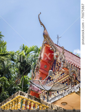 Buddhist temple roof with a satellite dish. Religion and modern technology 70875867