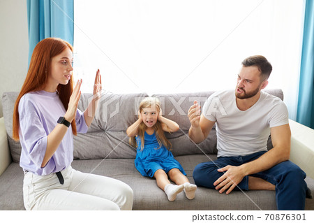 sad, desperate little girl during parents quarrel, she clog the ears sad, desperate little girl during parents quarrel, she clog the ears 70876301