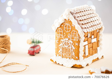 Christmas gingerbread house decoration on background of defocused lights. Hand decorated. 70876626