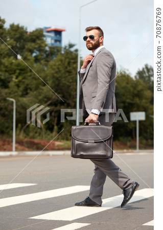 businessman commuting to office carrying his office bag businessman commuting to office carrying his office bag 70876769